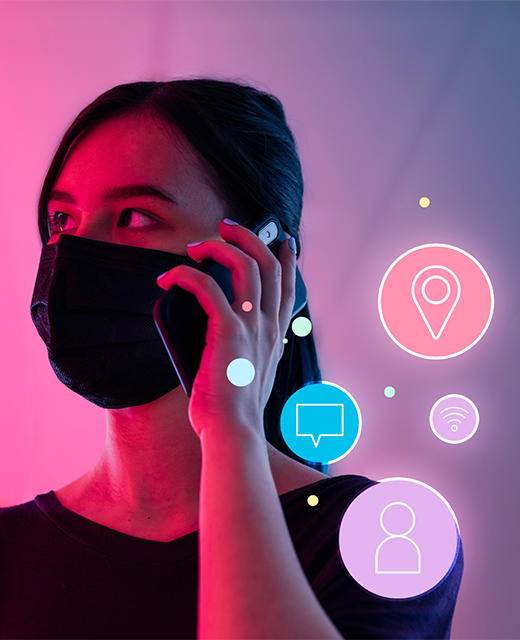 Woman wearing a black mask talking on phone with digital icons representing communication and location services.
